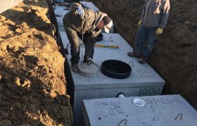 Septic waste tanks being installed into the ground