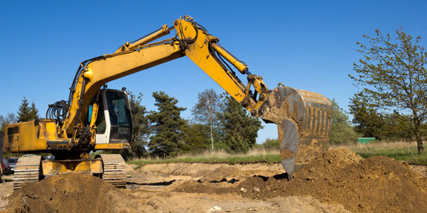 Excavator digging where a pool used to be